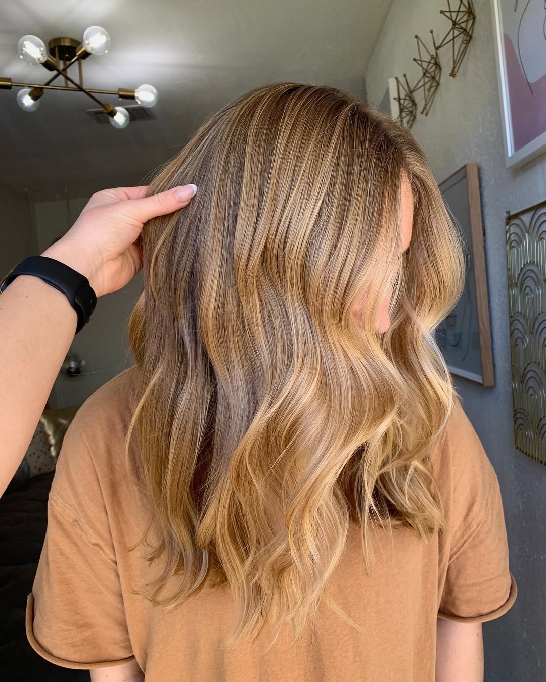 Gorgeous honey blonde hair color on mid-length wavy hair.