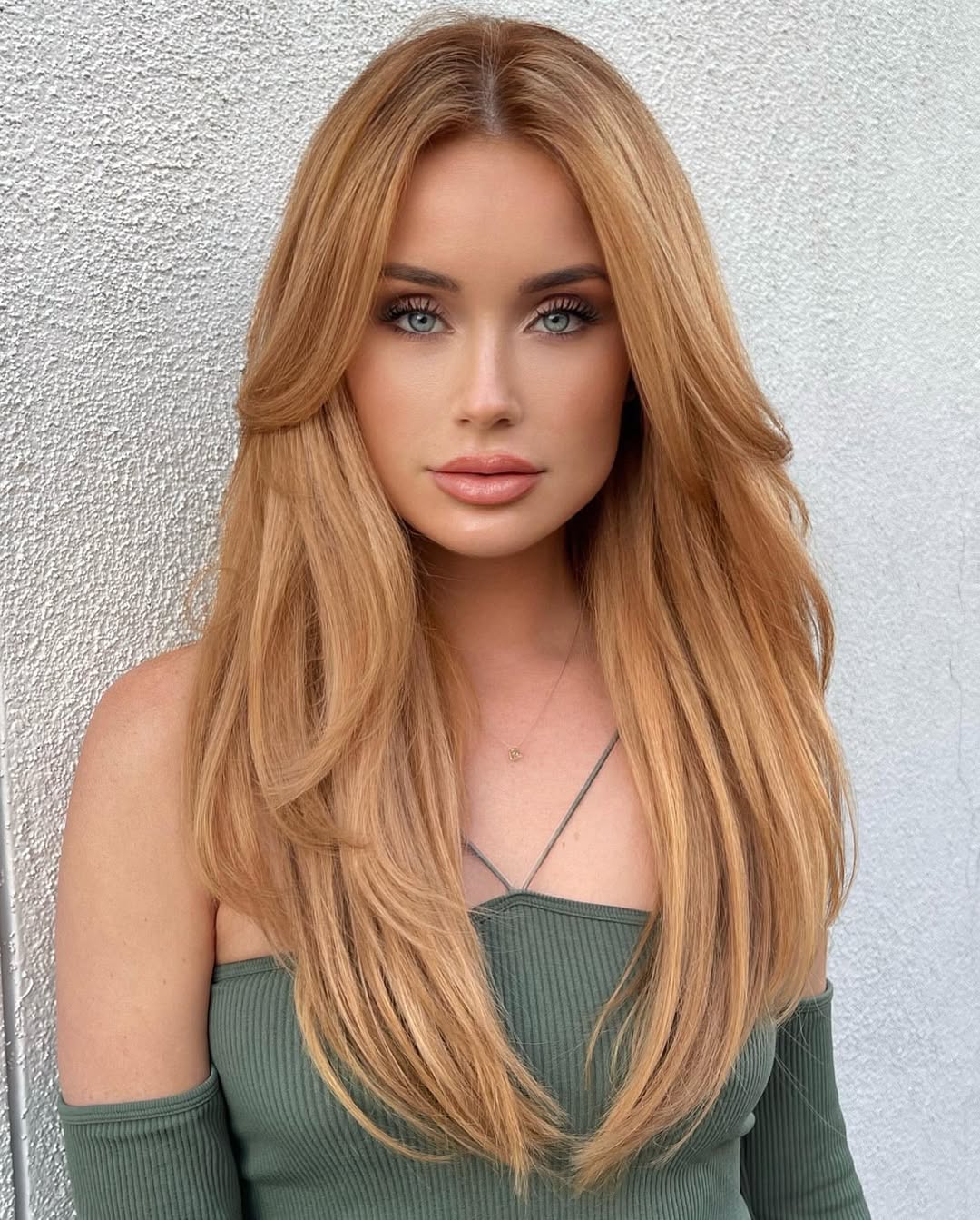 Gorgeous woman with golden blonde hair and piercing green eyes.