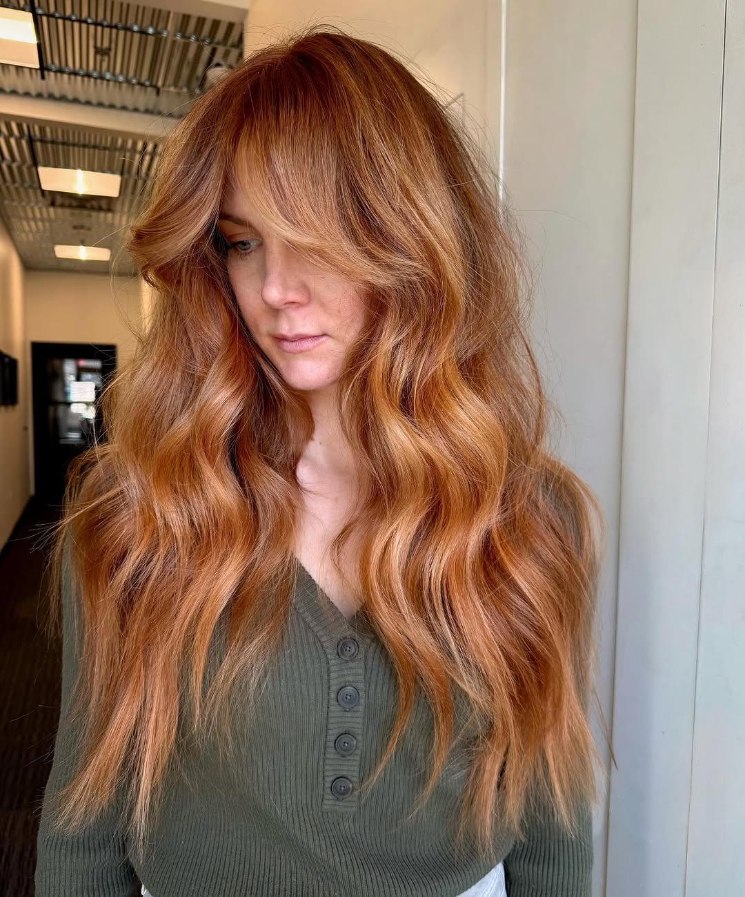 Gorgeous muted auburn hair color on long wavy hair.