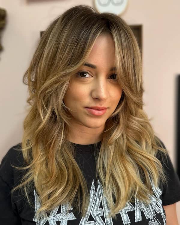 textured-haircut-with-long-framing-bangs-and-wispy-layers Textured Haircut with Long Framing Bangs and Wispy Layers