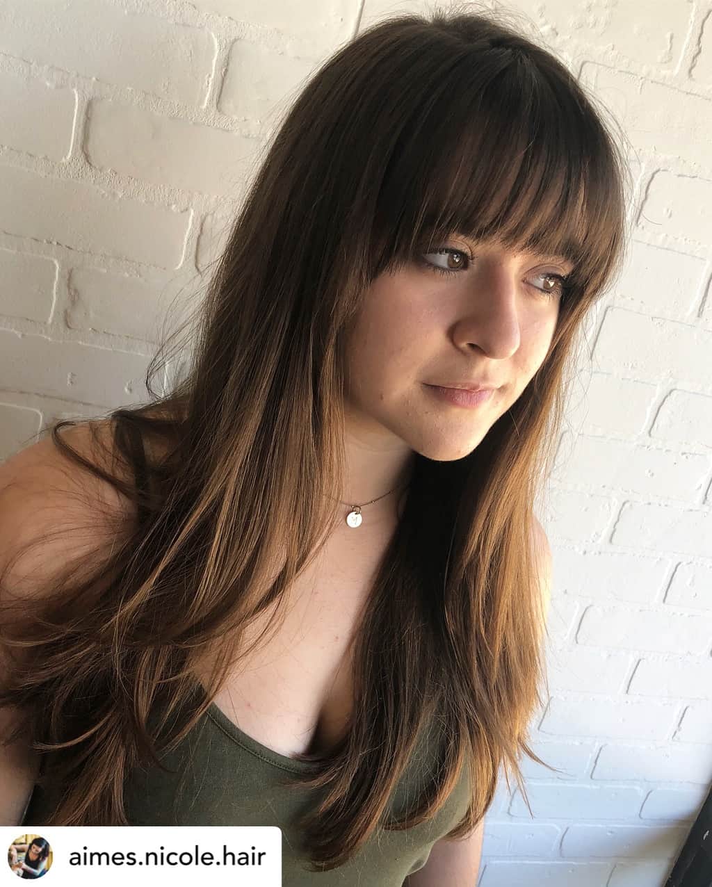 Curved bangs on beautiful brunette hair.