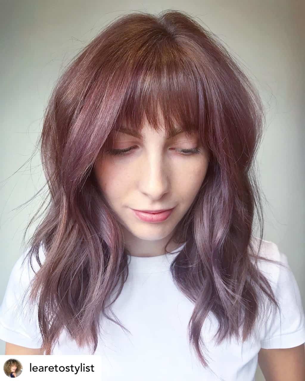 Textured bangs on beautiful brown and purple hair.