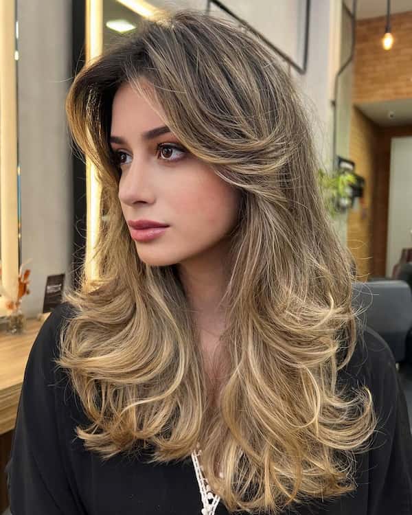 Voluminous Shaggy Hair with Feathered Layers and Bangs