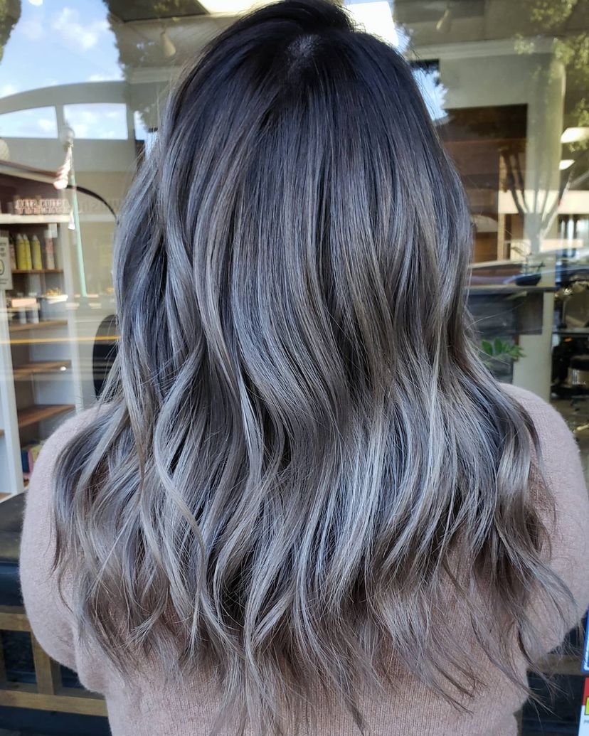 Woman with gorgeous smokey ash brown hair color for winter.