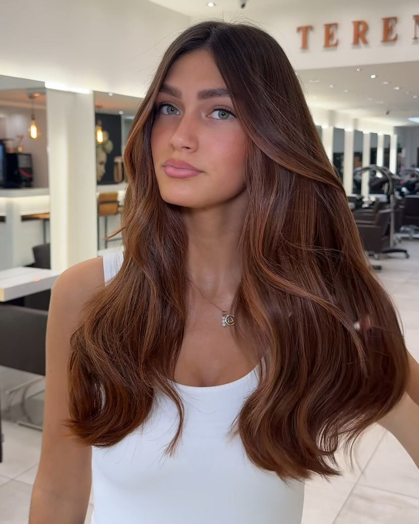 Woman with gorgeous cinnamon brown spice hair color for winter.