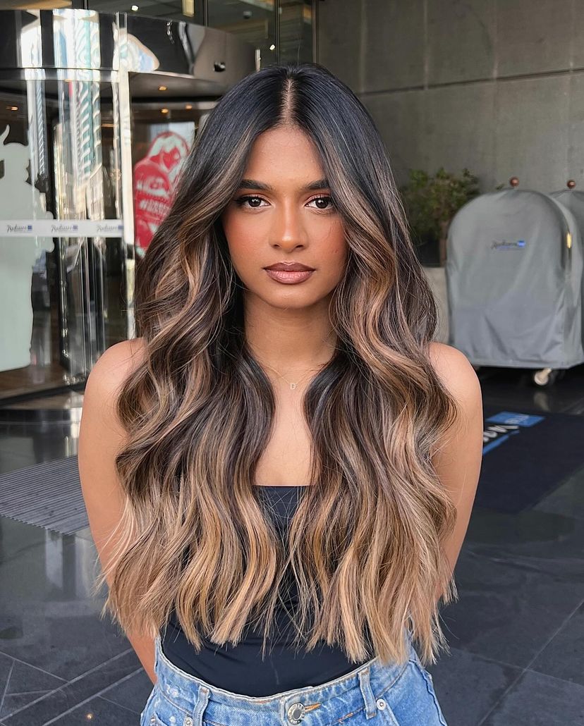 Woman with gorgeous pecan toffee ombre hair color for winter.